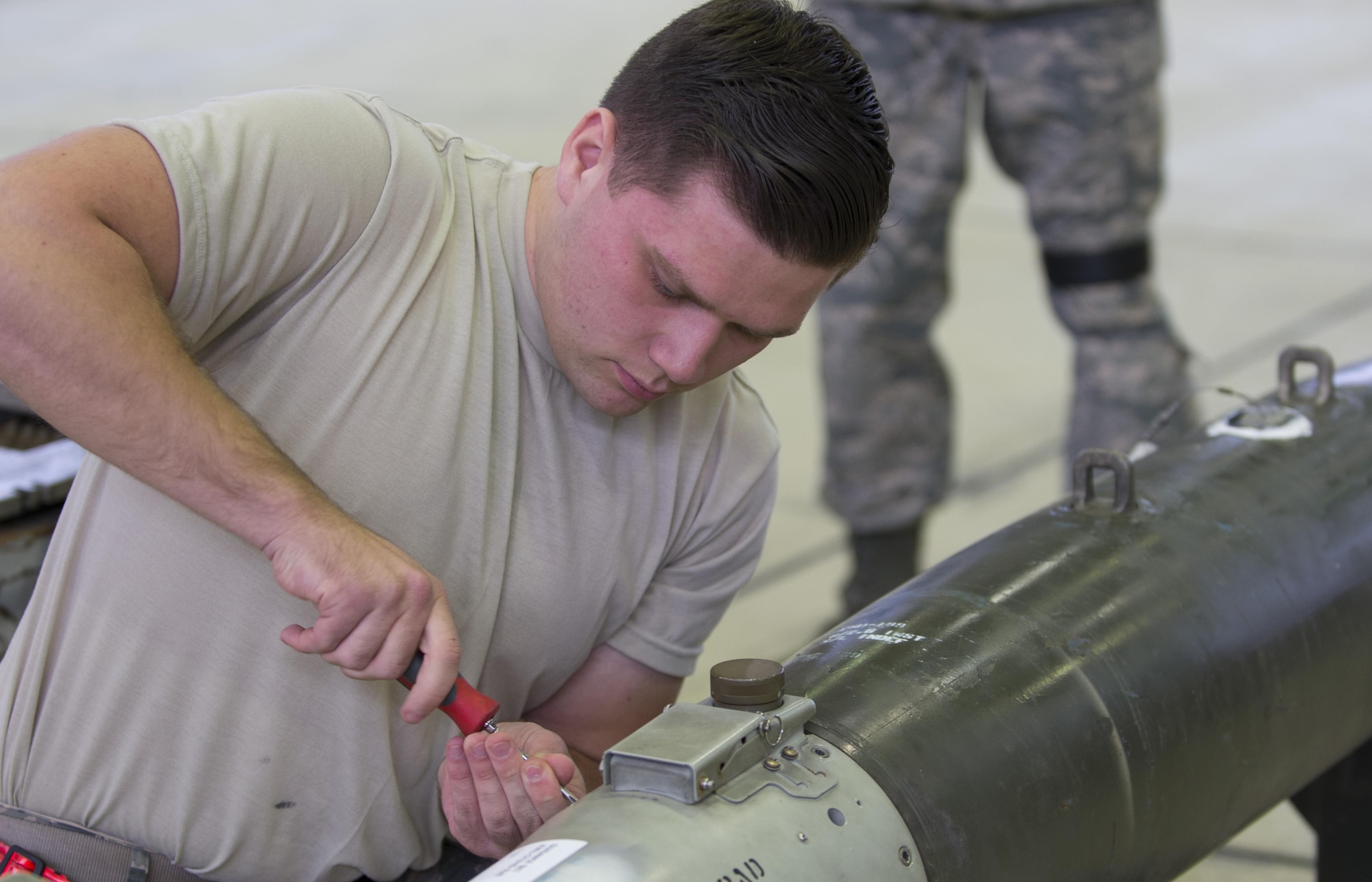 U.S. Air Force Airman 1st Class Christian Edson, 52nd Aircraft Maintenance Squadron tactical aircraft weapons systems specialist, prepares a dummy missile before loading it to an F-16 Fighting Falcon at Spangdahlem Air Base, Nov. 10, 2016. Family, friends and members of the Spangdahlem community attended the competition to see which of the two teams of three maintenance Airmen would move on to the annual load competition. (U.S. Air Force photo by Senior Airman Dawn M. Weber)