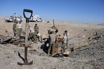 Members of the 386th Expeditionary Civil Engineer Squadron Explosive Ordnance Disposal flight load unserviceable ammunition into wooden boxes at an undisclosed location in Southwest Asia Nov. 9, 2016. The unserviceable ammunition consists of unexploded ordnance found on or off base and ammunition turned in by the 386th Munitions flight. (U.S. Air Force photo by Senior Airman Andrew Park)