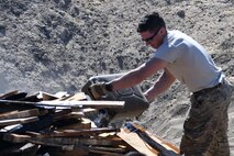 Tech Sgt. Daniel Hipps, 386th Explosive Ordnance Disposal team leader, pours fuel onto a munitions burn pile in preparation to destroy unserviceable ammunition at an undisclosed location in Southwest Asia Nov. 9, 2016. (U.S. Air Force photo by Senior Airman Andrew Park)