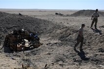 Tech Sgt. Cody Cochran, 386th Explosive Ordnance Disposal team leader, left, and Staff Sgt. Ryan Beckmann, 386th Explosive Ordnance Disposal team member, right, make their way back to the safe area so that they can initiate the burn process at an undisclosed location in Southwest Asia Nov. 9, 2016. (U.S. Air Force photo by Senior Airman Andrew Park)