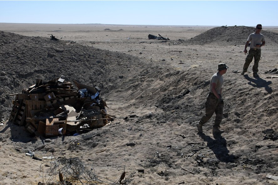 Tech Sgt. Cody Cochran, 386th Explosive Ordnance Disposal team leader, left, and Staff Sgt. Ryan Beckmann, 386th Explosive Ordnance Disposal team member, right, make their way back to the safe area so that they can initiate the burn process at an undisclosed location in Southwest Asia Nov. 9, 2016. (U.S. Air Force photo by Senior Airman Andrew Park)