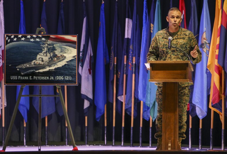 Brig. Gen. Matthew Glavy speaks during a ceremony at Marine Corps Air Station Cherry Point, N.C., Nov. 9, 2016. During the ceremony, Secretary of the Navy, the Honorable Ray Mabus announced that the Arleigh Burke-class destroyer, DDG 121, will be named the USS Frank E. Petersen Jr., in honor of the Marine Corps lieutenant general who was the first African-American Marine Corps aviator and the first Marine Corps general officer. Petersen was the first African-American Marine Corps aviator and general officer. He retired from the Marine Corps in 1988 after 38 years of service. Glavy is the commanding general of 2nd Marine Aircraft Wing. (U.S. Marine Corps photo by Cpl. Jason Jimenez/ Released)