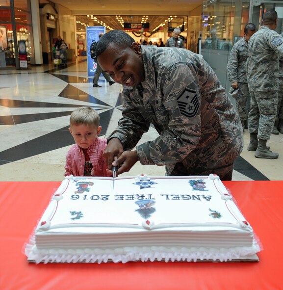 Master Sgt. Timothy Bedford, 21st Operational Weather Squadron First Sergeant, and Wyatt Jacobs, son of Chief Master Sgt. Taylor Jacobs, 21st Operational Weather Squadron superintendent, cut a cake at the 2016 Angel Tree ceremony at Ramstein Air Base, Germany, Nov. 8, 2016.
Last year, more than 200 families received donations, affecting more than 400 children’s lives. (U.S. Air Force photo by Airman 1st Class Savannah L. Waters)
