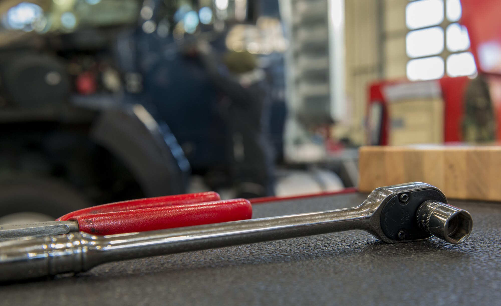 A socket wrench lies on a tool chest at the 86th Vehicle Readiness Squadron at Ramstein Air Base, Germany, Nov. 14, 2016. Hendrik Ecker, 86th VRS vehicle mechanic technician, was provided a position in the squadron to learn vehicle maintenance by Ramstein’s Local National Apprenticeship program. Ramstein hopes to continue to build and maintain a strong partnership with the local community through this program. (U.S. Air Force photo by Senior Airman Tryphena Mayhugh)