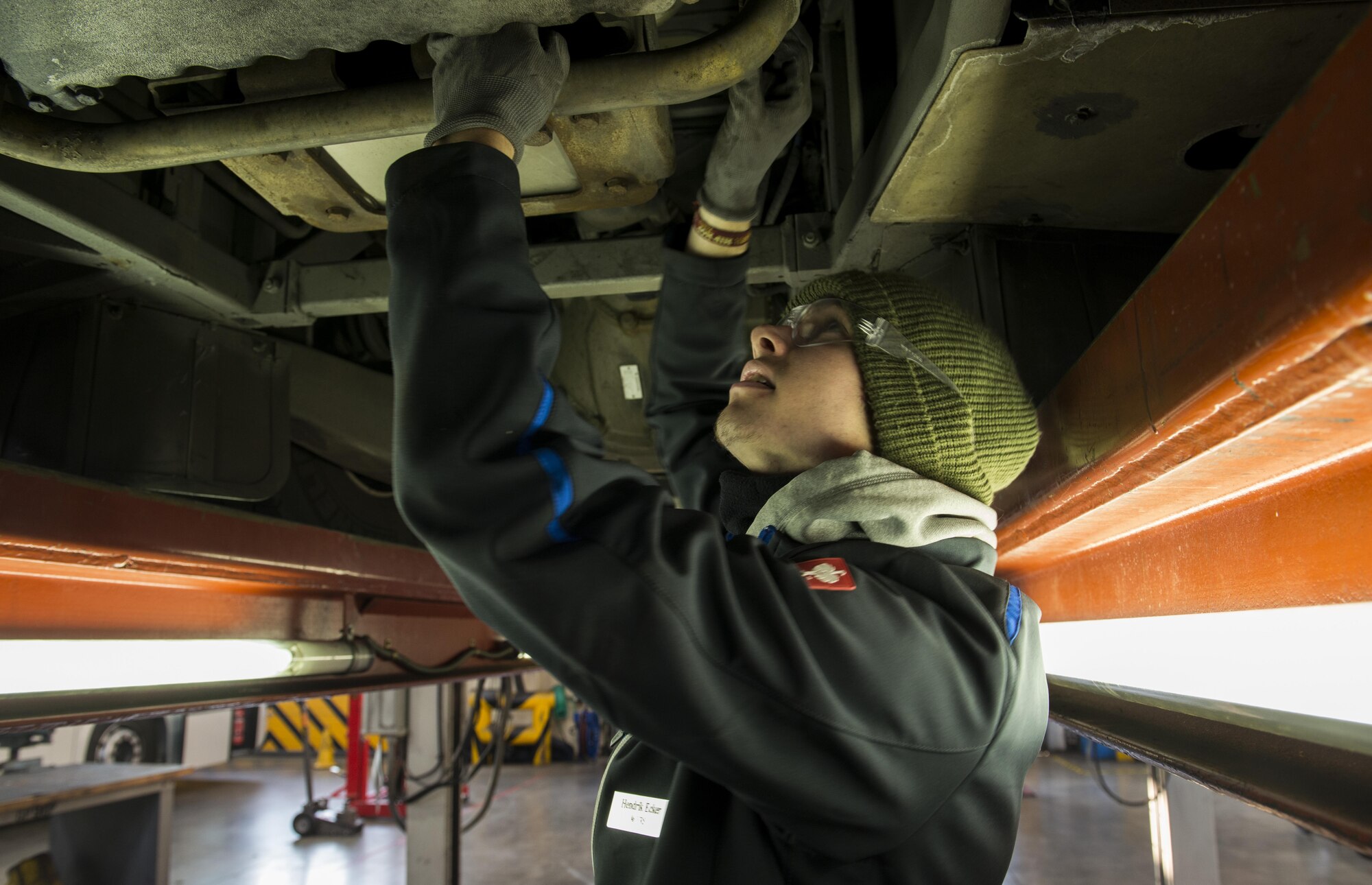 Hendrik Ecker, 86th Vehicle Readiness Squadron vehicle mechanic technician, works on the undercarriage of a bus at Ramstein Air Base, Germany, Nov. 14, 2016. Ecker was partnered the 86th VRS through Ramstein’s Local National Apprenticeship program, which is designed to mirror the German vocational system and provide practical hands-on skills as well as classroom education for young adults. He was one of 21 local nationals to be chosen for the program. (U.S. Air Force photo by Senior Airman Tryphena Mayhugh)
