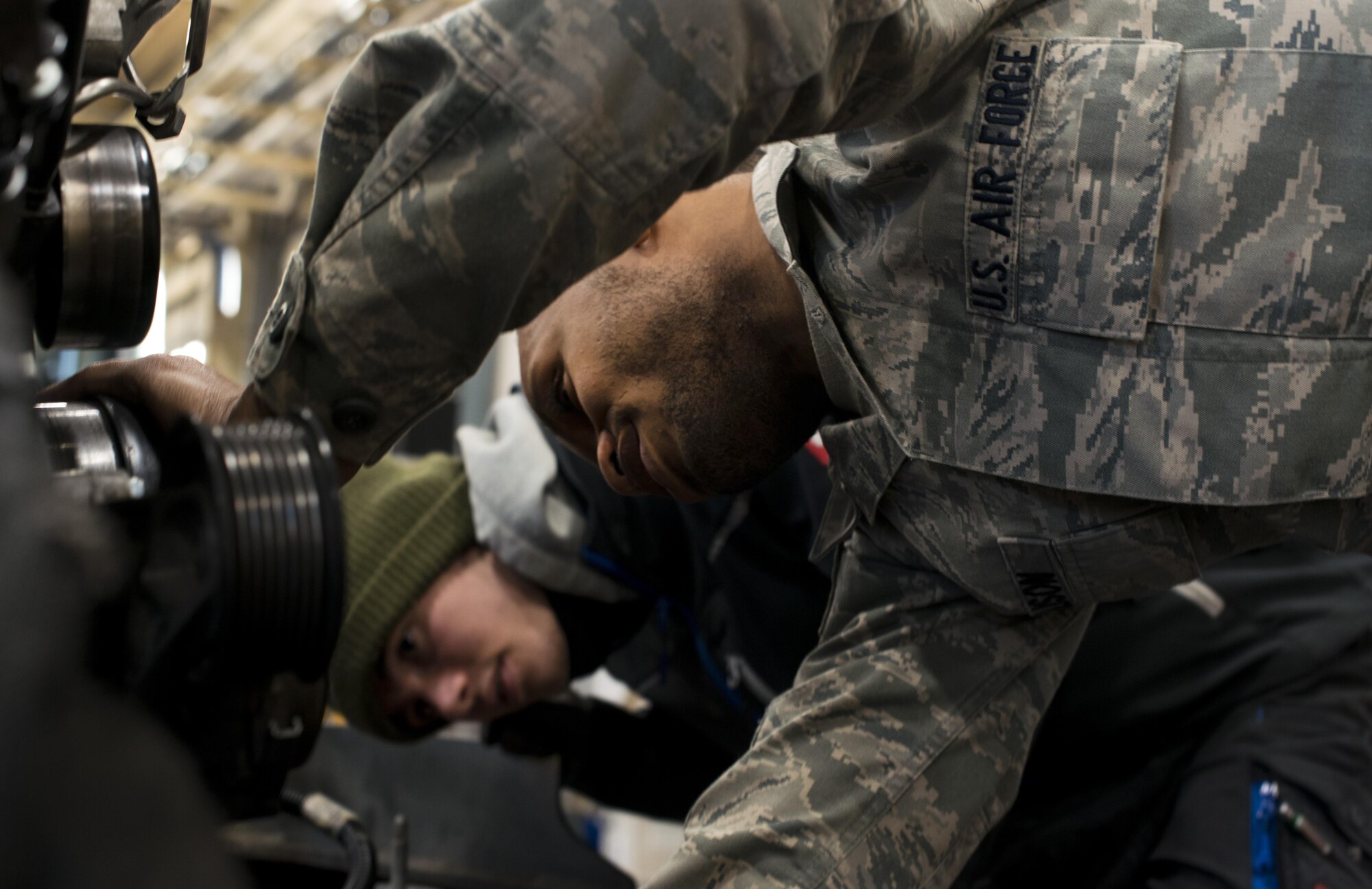 Staff Sgt. Travias Ellison, 86th Vehicle Readiness Squadron mission generation technician, shows Hendrik Ecker, 86th VRS vehicle mechanic technician, the engine of a 4 Bobtail vehicle at Ramstein Air Base, Germany, Nov. 14, 2016. Ecker, along with 20 other local nationals, partnered with Ramstein to receive practical hands-on skills as well as classroom education in their respective field. (U.S. Air Force photo by Senior Airman Tryphena Mayhugh)