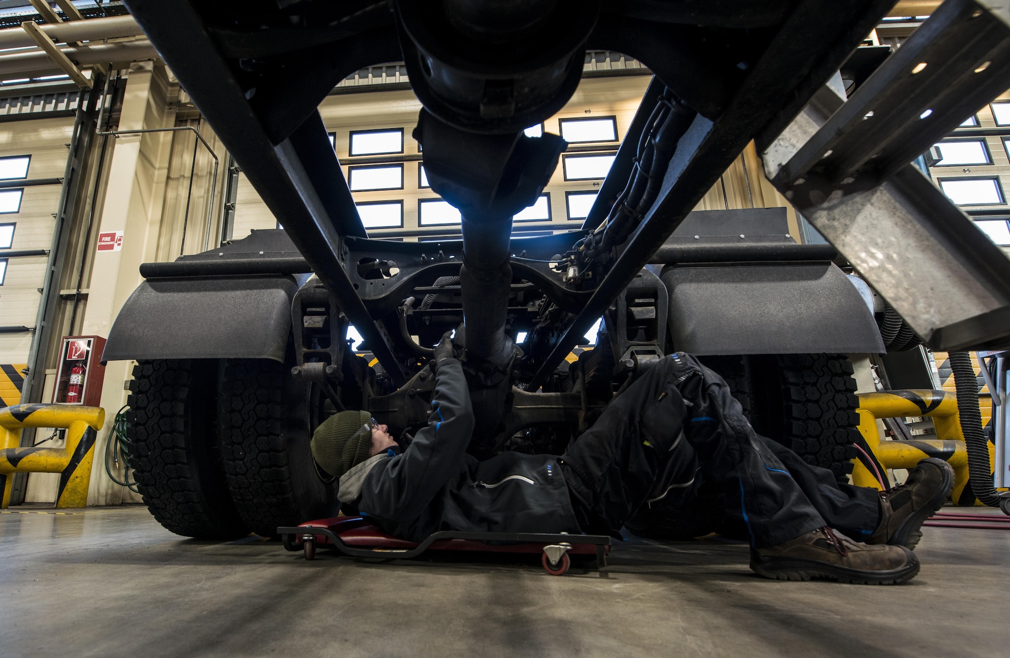 Hendrik Ecker, 86th Vehicle Readiness Squadron vehicle mechanic technician, works on the axle of a tractor trailer vehicle at Ramstein Air Base, Germany, Nov. 14, 2016. Ecker applied for Ramstein’s Local National Apprenticeship program and was provided a position in the 86th VRS to study vehicle maintenance. Twenty other local nationals were chosen for the program, and Ramstein hopes to further the partnership it has fostered with the local community. (U.S. Air Force photo by Senior Airman Tryphena Mayhugh)