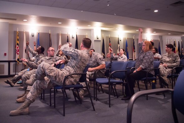 Green Dot training atendees throw pieces of paper  to one another during a class at Keesler Air Force Base, Miss. Nov. 5. that explain the different barriers bystanders may have to intervening in a negative situation. Green Dot is the U.S. Air Force's program to help raise awareness of and prevent sexual assault, domestic violence and stalking. (U.S. Air Force photo/Staff Sgt. Heather Heiney)