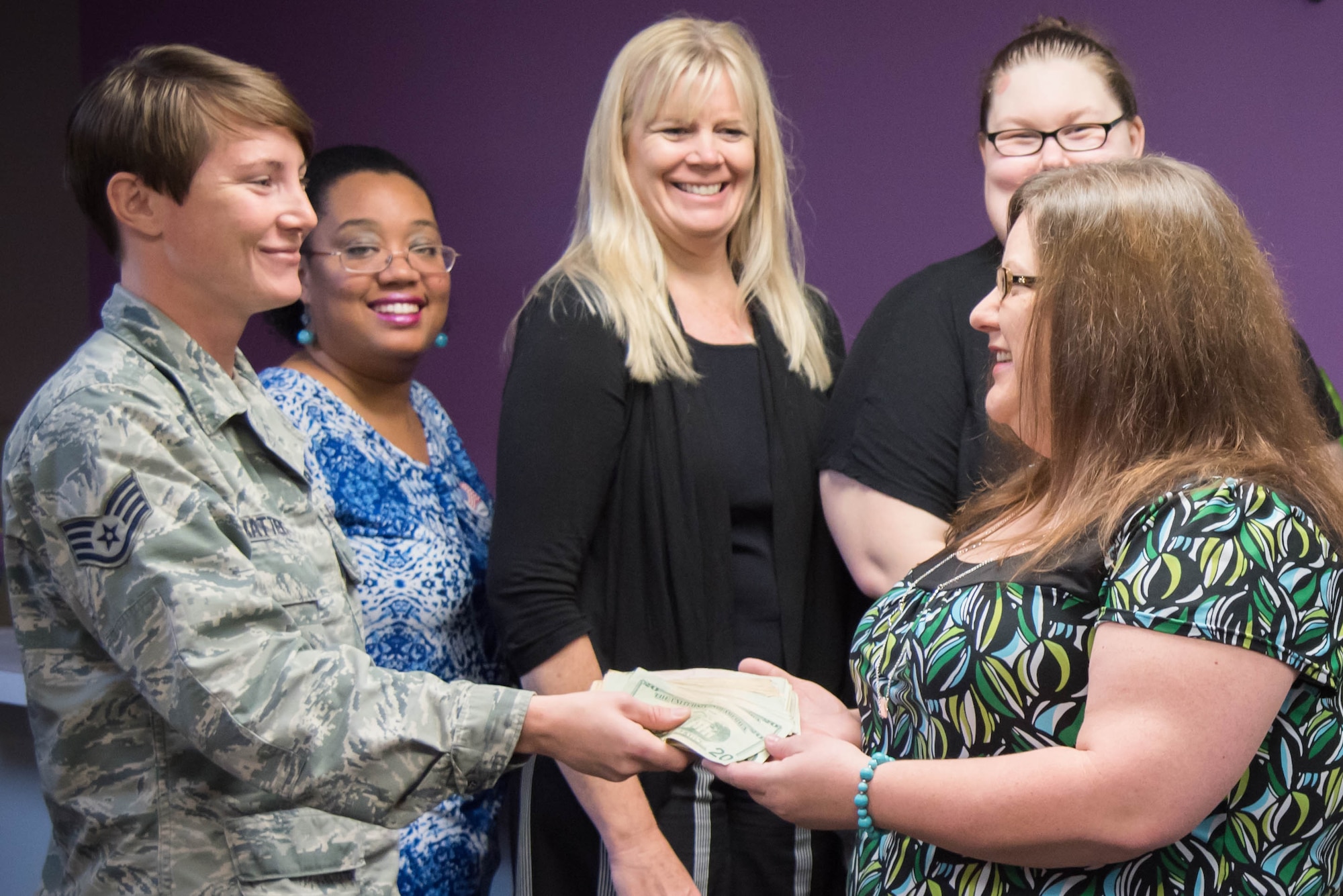 Staff Sgt. Lacey Matthews, 403rd Aircraft Maintainance Squadron crew chief, presents a donation to the Gulf Coast Women's Center for Nonviolence. 403rd Wing members raised more than $1,300 as part of their support of the Green Dot program, which is the U.S. Air Force's program to help raise awareness of and prevent sexual assault, domestic violence and stalking.(U.S. Air Force photo/Staff Sgt. Heather Heiney)