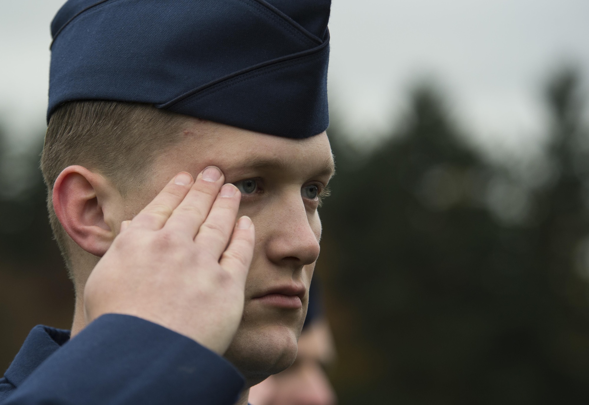 Senior Airman Joshua Dewberry, 52nd Fighter Wing Public Affairs photojournalist, salutes along with fellow Airmen during a Veterans Day memorial ceremony at the Luxembourg American Cemetery and Memorial in Hamm, Luxembourg City, Luxembourg, Nov. 11, 2016. Dewberry and more than 40 Pitsenberger Airmen Leadership School students from Spangdahlem Air Base, Germany, participated in the ceremony to honor the service and sacrifice of American veterans. (U.S. Air Force photo by Senior Airman Dawn M. Weber)