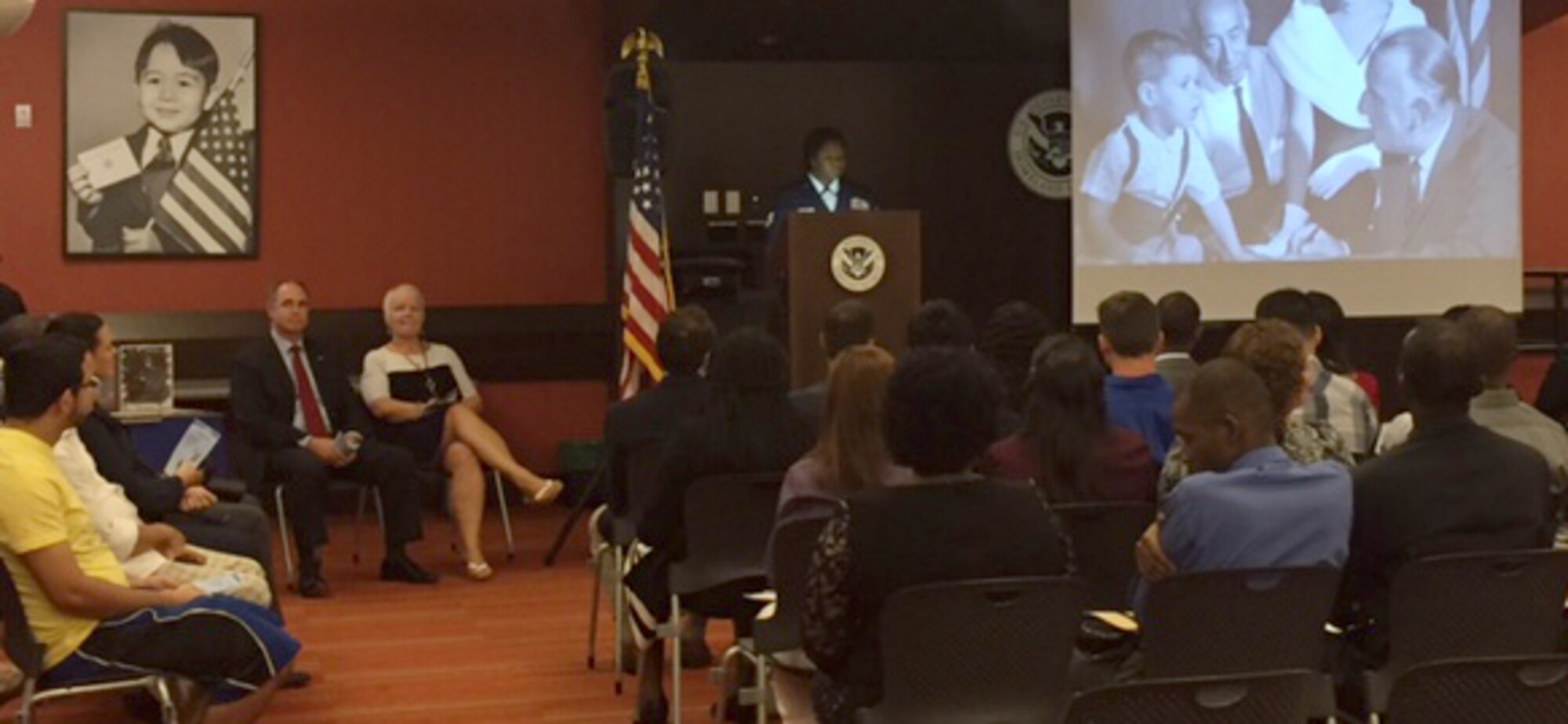 To commemorate Veteran's Day, Air Force Reservist Tech. Sgt. Angela Borders (front row, third from the left), 920th Force Support Squadron, Patrick Air Force Base, Florida, leads a U.S. Citizenship and Immigration Services Ceremony November 8, 2016. Borders works as an Immigration Services Officer in Orlando when she's not serving the country. (Courtesy photo)