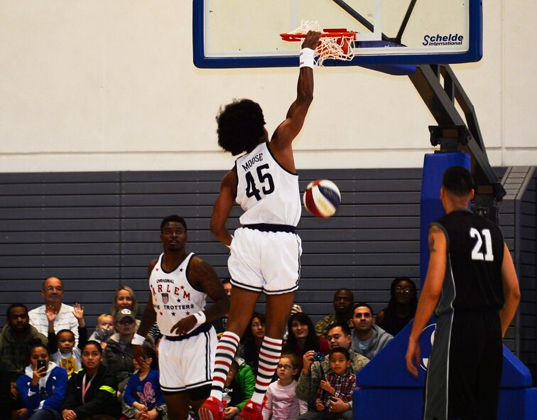 A Harlem Globetrotter dunks the ball during a game at Ramstein Air Base, Germany, Nov. 10, 2016. The event was sponsored by the 86th Force Support Squadron, Armed Forces Entertainment, and Navy. (U.S. Air Force photo by Airman 1st Class Joshua Magbanua)