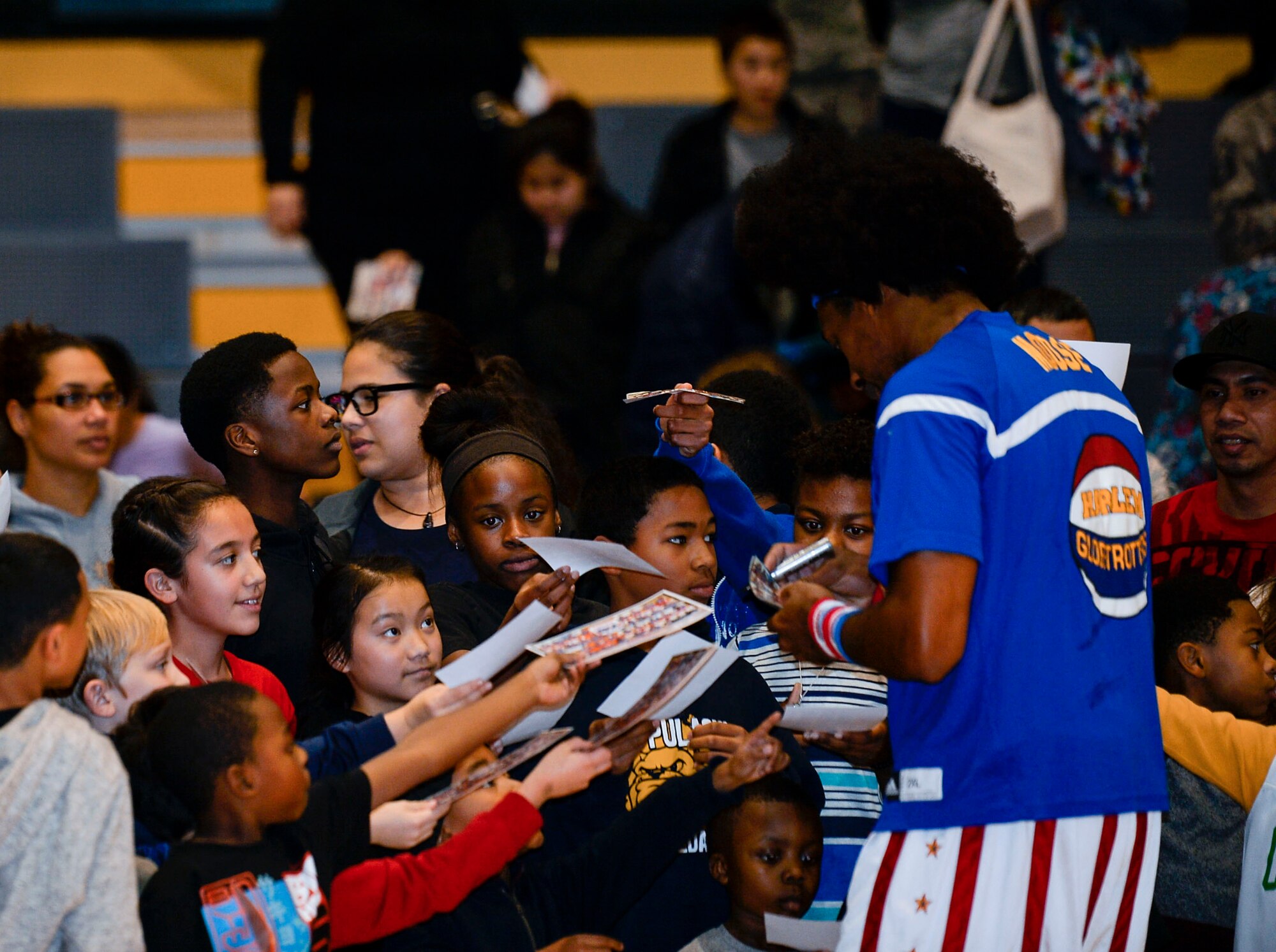 A Harlem Globetrotter signs autographs after a game at Ramstein Air Base, Germany, Nov. 10, 2016. The basketball exhibition group has been performing for U.S. troops overseas for more than 10 years. (U.S. Air Force photo by Airman 1st Class Joshua Magbanua)