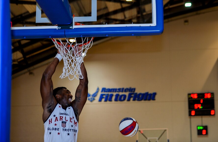 A Harlem Globetrotters team member attempts a slam dunk during a game at Ramstein Air Base, Germany, Nov. 10, 2016. The Harlem Globe Trotters have been conducting tours for U.S. troops stationed overseas for more than 13 years. The basketball exhibition team combines elements of sports, theater, and comedy to produce entertaining shows for its audiences.  (U.S. Air Force photo by Airman 1st Class Joshua Magbanua)