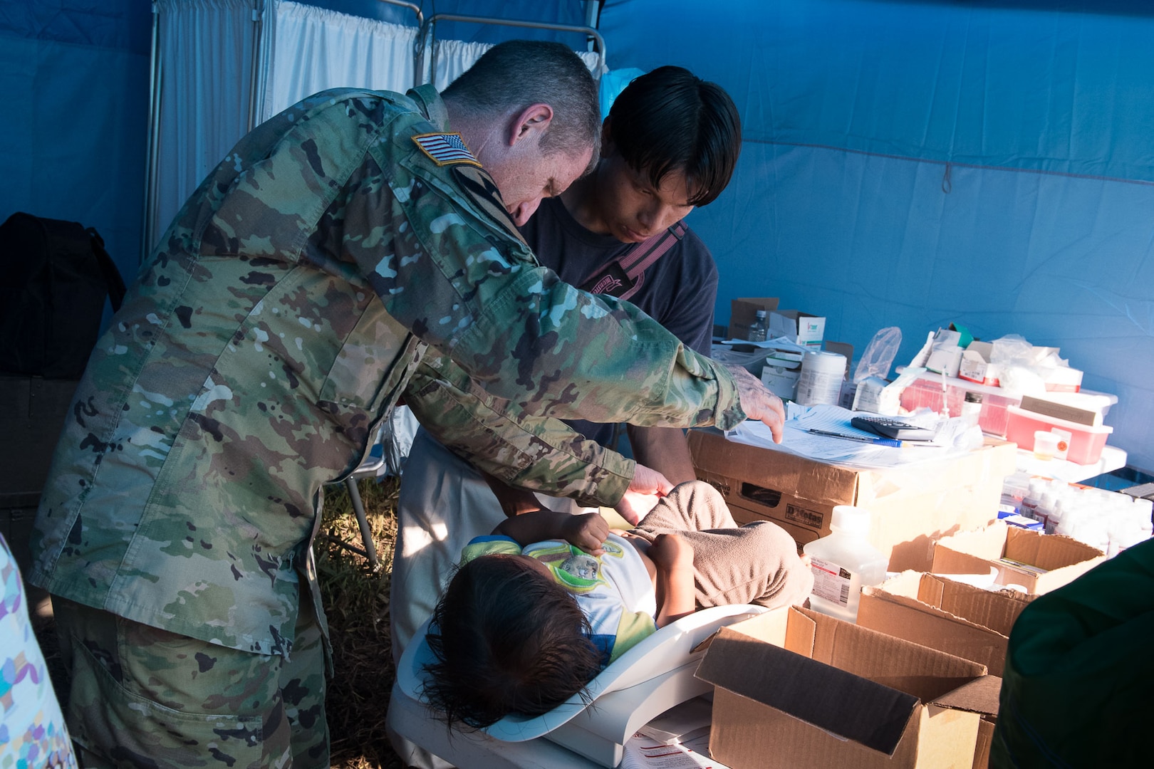 Colonel Douglas Lougee, Medical Element commander and pediatrician, weighs a child during Operation Pura Vida, a joint humanitarian mission and Medical Readiness Training Exercise at an indigenous region in the Caribbean province of Limón, Nov. 2. A Group of 16 JTF-Bravo medical professionals arrived in four helicopters from the 1st Battalion 228th Aviation Regiment and joined 30 Costa Rican physicians to provide basic healthcare services to approximately 300 residents of the indigenous village of Piedra Mesa, Telire region of Talamanca, Limón.