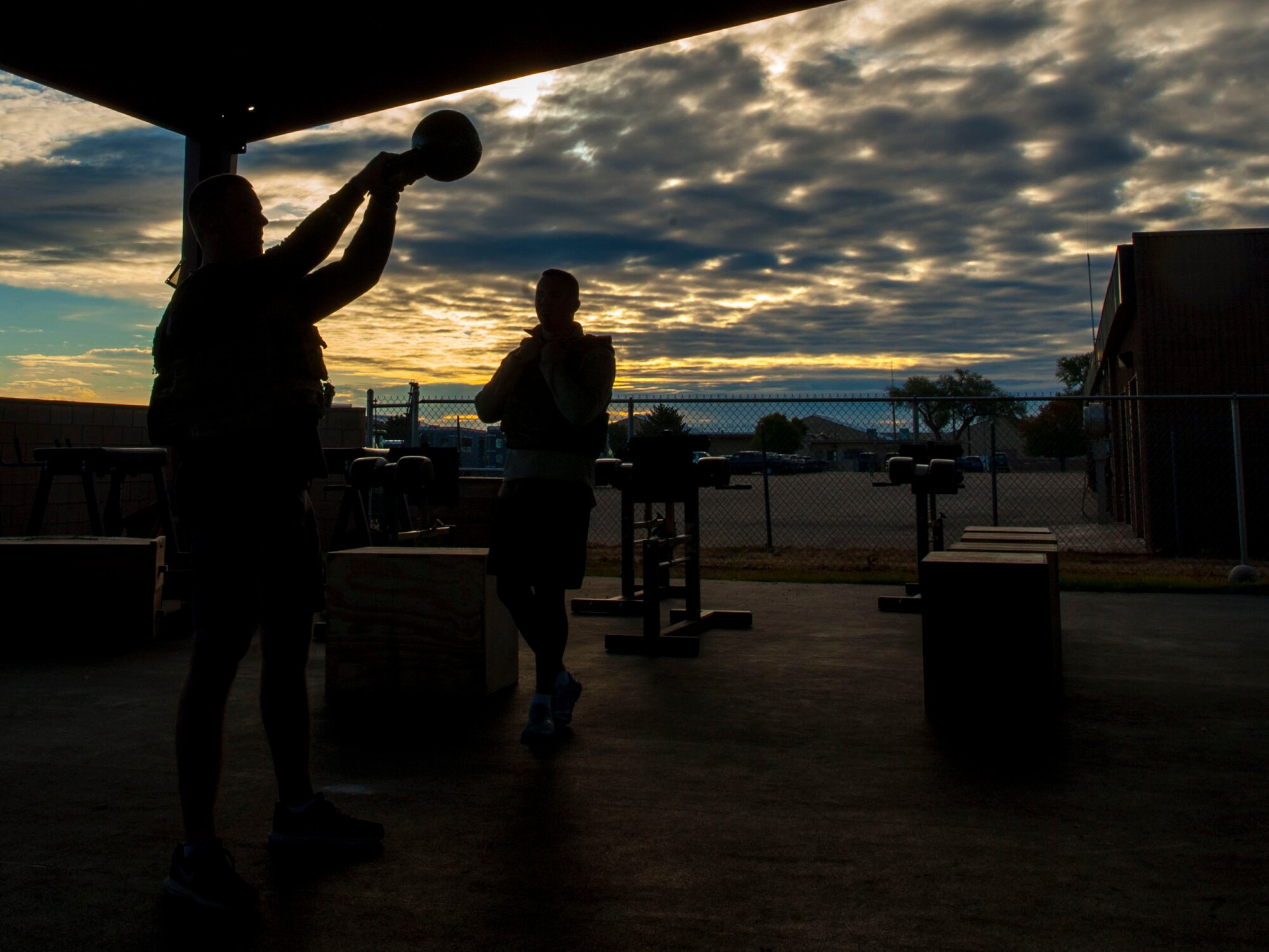 U.S. Air Force 2nd Lt. Stephen Bukowski, Special Operations Civil Engineer Squadron project manager and 1st Lt. Jay Pearson, 27th SOCES base energy manager, perform kettle bell swings during the 3rd annual EOD 132 workout Nov. 10, 2016 at Cannon Air Force Base, N.M.. This annual workout is in honor of the 132 EOD technicians who have passed away since the 9/11 tragedy. (U.S. Air Force photo by Staff Sgt. Eboni Reams/Released)