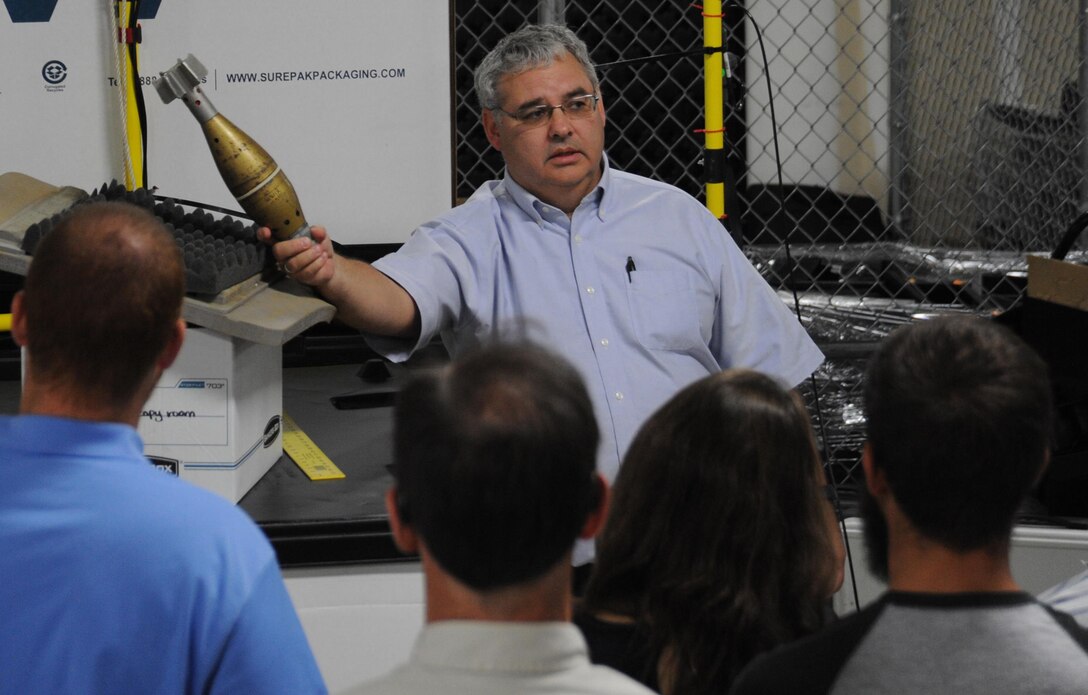 Bob Selfridge, a Huntsville Center geophysicist uses an inert munition during a Visual Sample Plan training session Oct. 27. The training focused on the footprint reduction and remediation of unexploded ordnance sites module of Visual Sample Plan, a software tool used to support Formerly Used Defense Sites remediation processes.