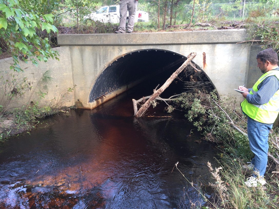 Patrick Hager, a Savannah District structural engineer, inspects an impacted culvert on Fort Bragg in North Carolina Oct. 14, 2016. The structure located downstream of a water crossing, was inaccessible due to fencing barriers and partial overtopping from debris. 