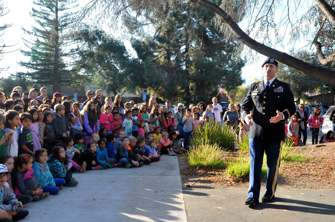 Col. Lewis Knapp, legislative liaison, 63rd Regional Support Command, talks to elementary students about the significance of the U.S. flag and Veterans Day at a flag raising ceremony conducted by the 63rd Regional Support Command, Nov. 10, Christa McAuliffe Elementary School, Saratoga, Calif. (U.S. Army Reserve photo by Alun Thomas, 63rd RSC Public Affairs)