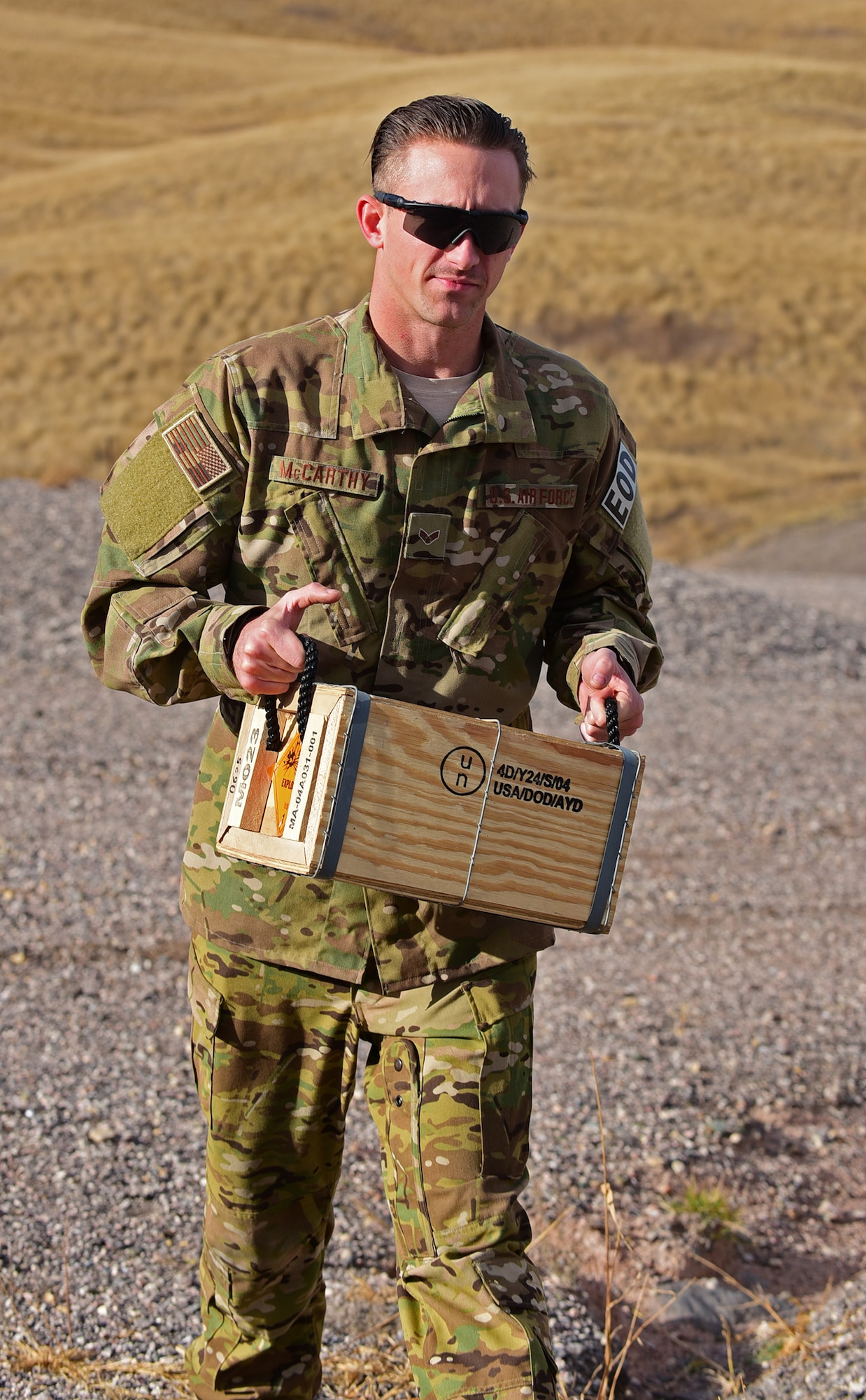 Senior Airman Zachary McCarthy, explosive ordnance disposal apprentice assigned to the 28th Civil Engineer Squadron, carries a box of explosives at Ellsworth Air Force Base S.D., Nov. 14, 2016. The box contains a plastic explosive used to detonate unexploded ordinance. (U.S. Air Force photo by Airman 1st Class James L. Miller)