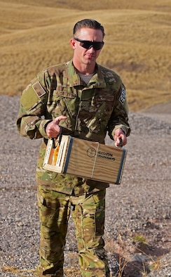 Senior Airman Zachary McCarthy, explosive ordnance disposal apprentice assigned to the 28th Civil Engineer Squadron, carries a box of explosives at Ellsworth Air Force Base S.D., Nov. 14, 2016. The box contains a plastic explosive used to detonate unexploded ordinance. (U.S. Air Force photo by Airman 1st Class James L. Miller)