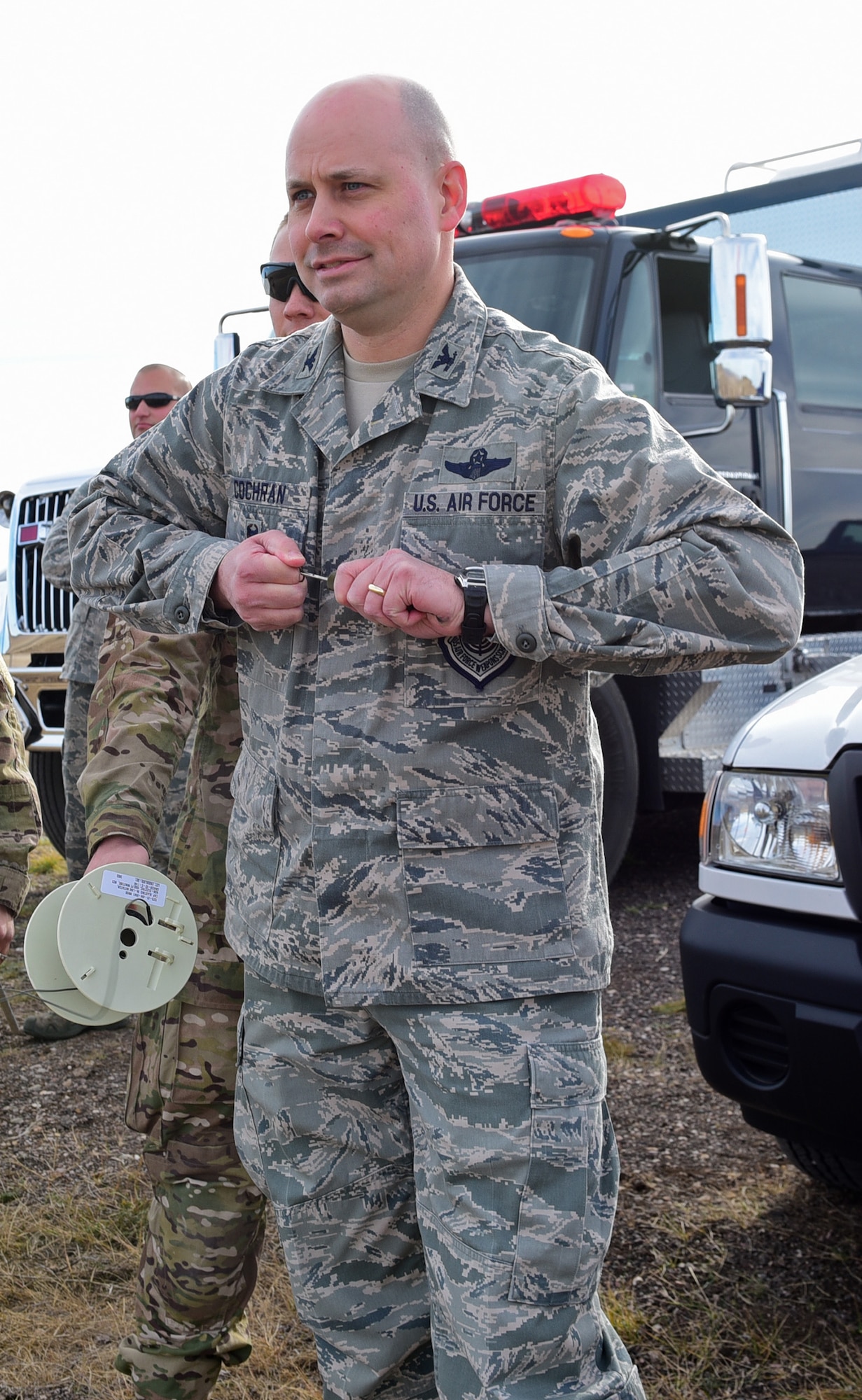 Col. Bradley Cochran, vice commander of the 28th Bomb Wing, pulls a pin to trigger an explosion at Ellsworth Air Force Base, S.D., Nov. 14, 2016. From a safe distance away, Cochran was given the opportunity to conduct a controlled explosion simulating expeditionary operations. (U.S. Air Force photo by Airman 1st Class James L. Miller)