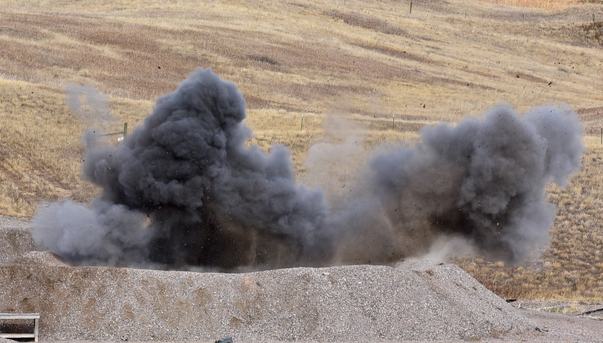 A controlled explosive ordnance disposal creates a cloud of smoke at Ellsworth Air Force Base, S.D., Nov. 14, 2016. The explosion was part of a display to demonstrate the capabilities of EOD Airmen. (U.S. Air Force photo by Airman 1st Class James L. Miller)