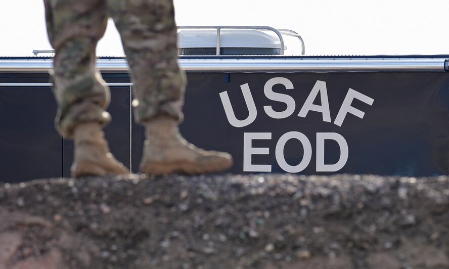 An explosive ordnance disposal member stands in front of an EOD vehicle during a controlled explosion display at Ellsworth Air Force Base, S.D., Nov. 14, 2016. EOD demonstrated the steps of setting up an explosion to a group of Airmen from various squadrons to showcase their abilities. (U.S. Air Force photo by Airman 1st Class James L. Miller)  