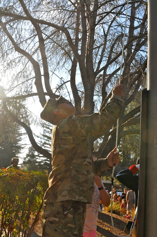 Staff Sgt. Juan Martinez (left), senior human resource specialist, 63rd RSC, raises the U.S. flag during a flag raising ceremony, Nov. 10, Christa McAuliffe Elementary School, Saratoga, Calif. (U.S. Army Reserve photo by Alun Thomas, 63rd RSC Public Affairs)