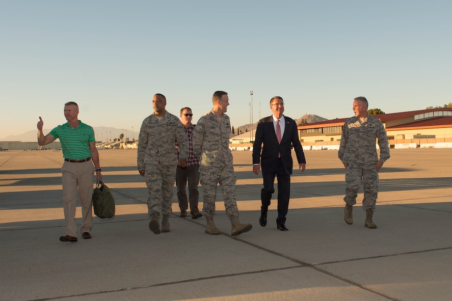 Defense Secretary Ash Carter, second from right, walks with senior leaders after arriving at March Air Reserve Base near Riverside, Calif.
