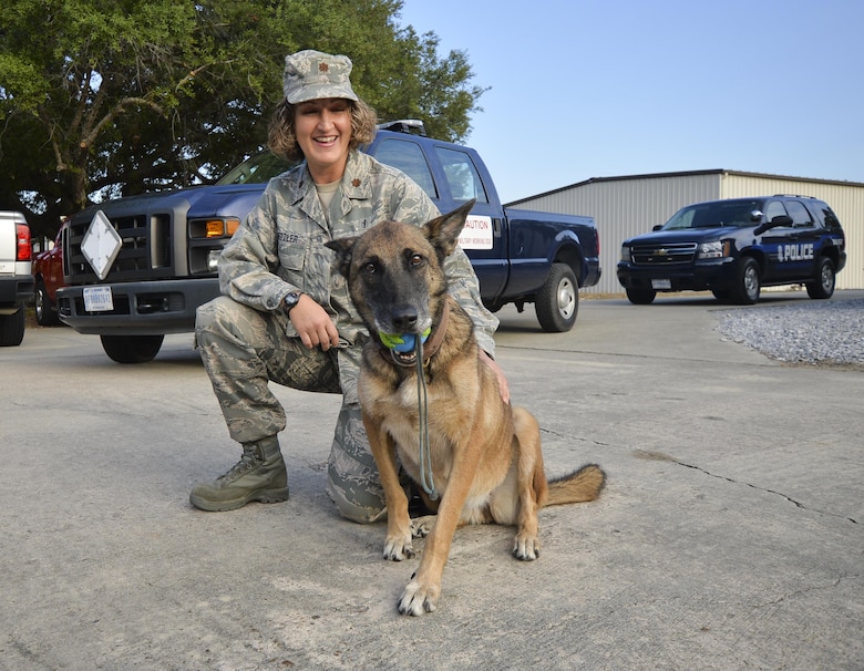 U.S. Air Force Maj. Mari Metzler, 325th Aerospace Medical Squadron aerospace physiology flight commander and retired Military Working Dog, Mica T204 spend time together before Mica’s final patrol Nov. 14, 2016 at Tyndall Air Force Base. Metzler adopted Mica after she was released from the MWD section earlier this year. (U.S. Air Force photo by Tech. Sgt. Javier Cruz/Released)