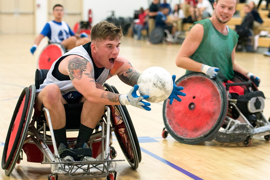 Marine Corps Lance Cpl. Dakota Boyer catches the ball at the goal line during a wheelchair rugby game at Joint Base Andrews, Md., Nov. 14, 2016. The game was one of several scrimmages during a sports clinic for wounded warriors. DoD photo by EJ Hersom