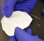 Navy researchers who are focused on helping injured warfighters are now able to weave chemicals and proteins into a nanofibrous scaffold, or wound dressing, (shown above) that may speed up healing and reduce scarring. Research by the NAMRU-SA provides a platform for the development of what can best be described as an antimicrobial super bandage.