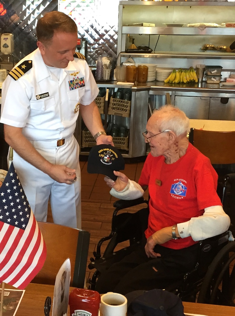 In celebration of his 100th birthday, Naval Aviator, Cmdr. Jeffrey Reynolds, executive officer, Navy Recruiting District San Antonio, presented a USS SAN ANTONIO (LPD-17) command ball cap to WWII Naval Aviator, Lt. Glen Shean during an Alamo Honor Flight Breakfast held at Denny’s, Nov. 7.   Shean, a Boerne resident and native of Cordell, Okla., served in the Navy as a TBF Avenger pilot from May 7, 1942 thru Oct. 1, 1946 aboard the USS Card (CVE-11), a Bogue-class escort aircraft carrier. 