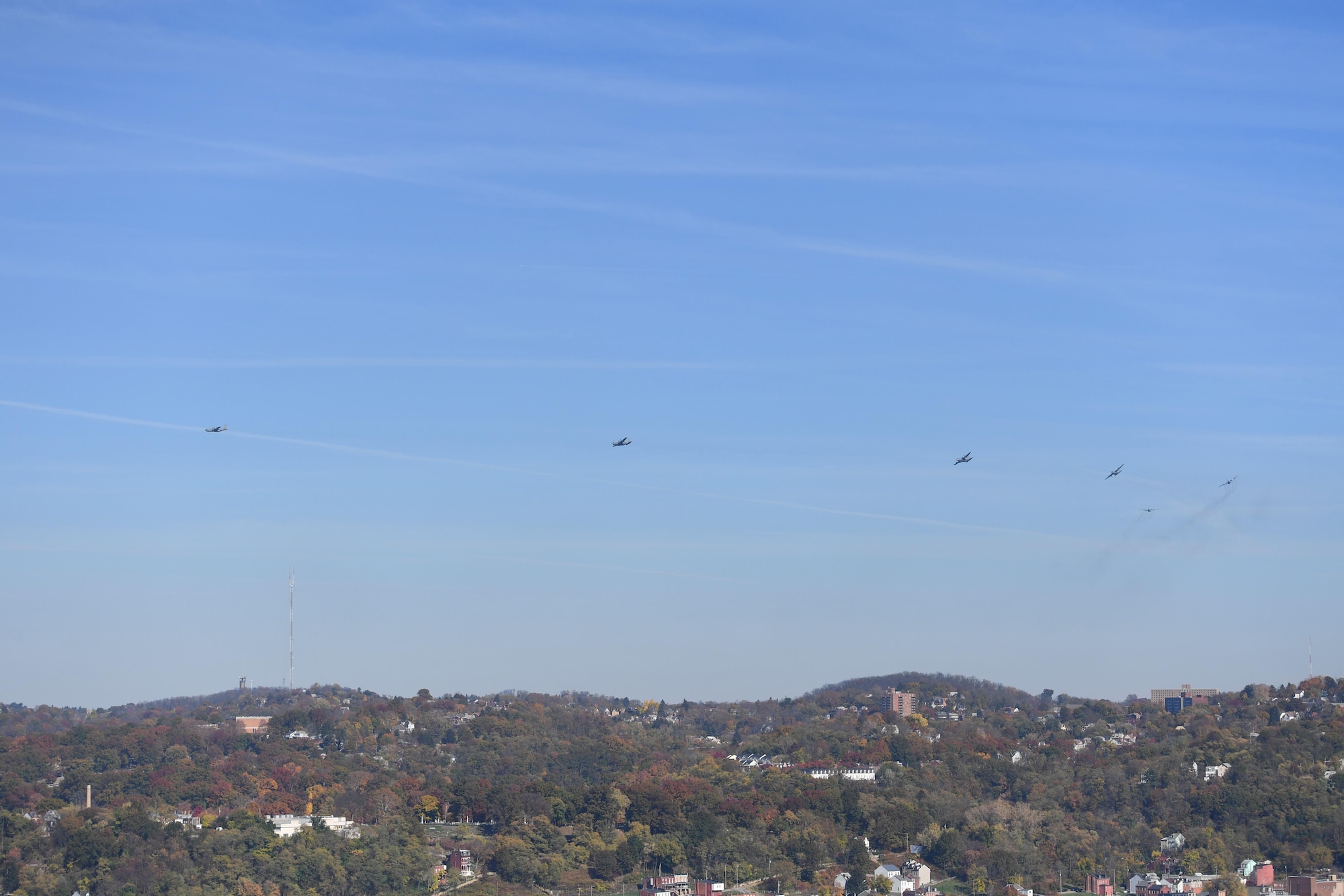Six C-130 Hercules aircraft fly over the fall foliage of Pittsburgh, Pennsylvania, during Exercise Steel Challenge 16-01, November 6, 2016. The exercise involved the simultaneous generation and launch of six aircraft that later split up to conduct separate training missions. (U.S. Air Force photo by Staff Sgt. Marjorie A. Bowlden)