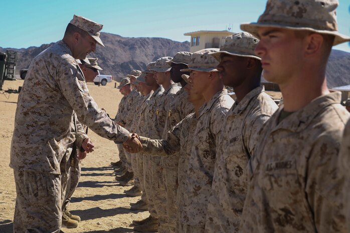 Maj. Gen. Daniel O’Donohue, the 1st Marine Division commanding general, pins the winning squad members from 1st Marine Division’s Super Squad Competition aboard Marine Corps Air-Ground Combat Center Twentynine, Palms, Calif., Aug. 15, 2016. Throughout the competition, the Marines faced various events that challenged them both mentally and physically. (U.S. Marine Corps photo by Cpl. Timothy Valero)