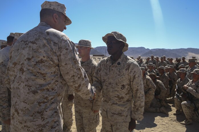 Maj. Gen. Daniel O’Donohue, the 1st Marine Division commanding general, congratulates Navy Hospital Corpsman Derek Calloway, a corpsman with Company C, 1st Battalion, 7th Marine Regiment, before pinning him with a super squad badge aboard Marine Corps Air-Ground Combat Center Twentynine Palms, Calif., Aug. 15, 2016. U.S. Navy Corpsman participate in the 1st Marine Division Super Squad Competition because they are critical members of a Marine Corps rifle squad. (U.S. Marine Corps photo by Cpl. Timothy Valero)