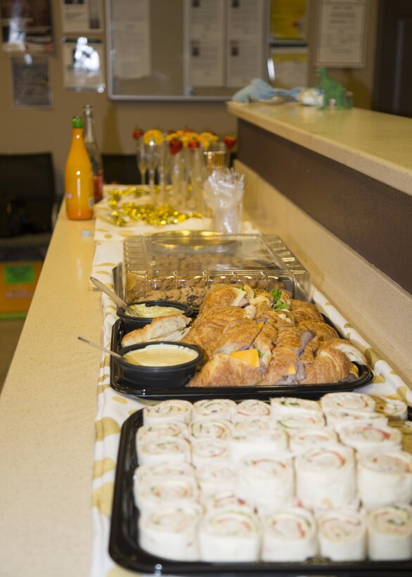 Food and beverages, provided by DRYKEF Inc., kept military spouses happy as they tried on gowns during Operation: My Girlfriend's Closet, held aboard Marine Corps Logistics Base Barstow, Calif., Nov. 9. The hostess, Leslie Beberniss, a Marine spouse, gathered donations of new and gently used dresses, jewelry and lotions, as well as sandwiches, cookies, mimosas and more, for the event so that military spouses could select beautiful gowns for the upcoming Marine Corps Birthday Ball. 
