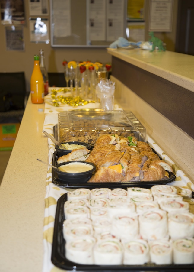 Food and beverages, provided by DRYKEF Inc., kept military spouses happy as they tried on gowns during Operation: My Girlfriend's Closet, held aboard Marine Corps Logistics Base Barstow, Calif., Nov. 9. The hostess, Leslie Beberniss, a Marine spouse, gathered donations of new and gently used dresses, jewelry and lotions, as well as sandwiches, cookies, mimosas and more, for the event so that military spouses could select beautiful gowns for the upcoming Marine Corps Birthday Ball. 