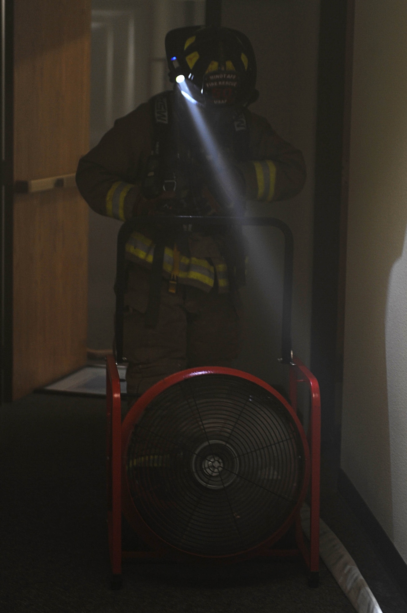 Airman 1st Class Roberto Vazquez, 5th Civil Engineer Squadron firefighter, ventilates smoke from a building during a training exercise at Minot Air Force Base, N.D., Nov. 9, 2016. The Fire Protection flight routinely trains to help protect people, property and the environment from fires on base. (U.S. Air Force photo/Senior Airman Kristoffer Kaubisch)