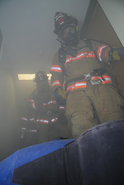 Firefighters from the 5th Civil Engineer Squadron find a dummy in a smoking room during a training exercise at Minot Air Force Base, N.D., Nov. 9, 2016. During the exercise, the flight responded to a call, searched a building for victims and determined the cause of the fire. (U.S. Air Force photo/Airman 1st Class Christian Sullivan)