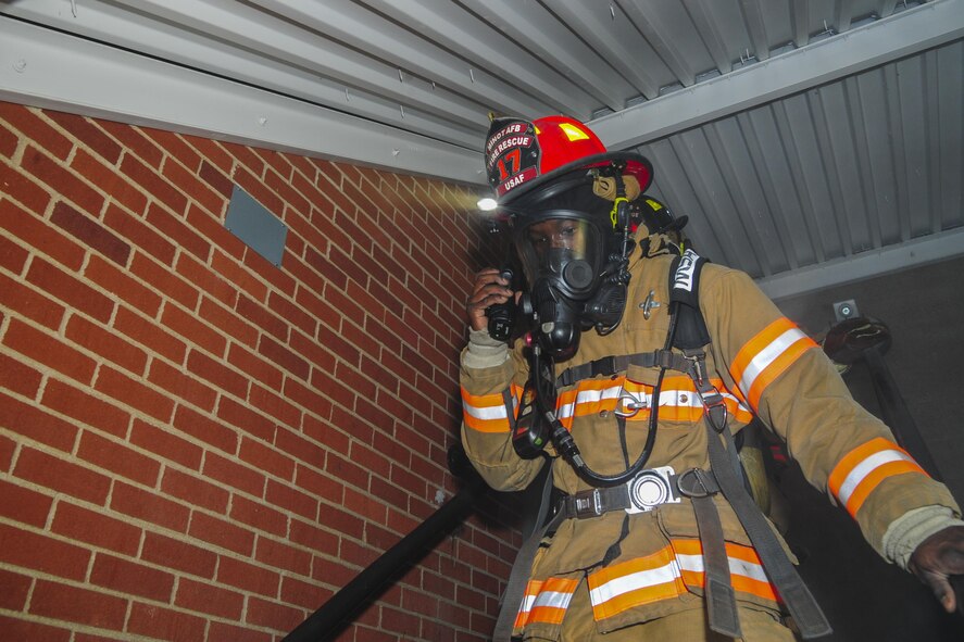 Senior Airman Brandon Vernon, 5th Civil Engineer Squadron firefighter, radios other firefighters during a training exercise at Minot Air Force Base, N.D., Nov. 9, 2016. During the exercise, the flight responded to a call, searched a building for victims and determined the cause of the fire. (U.S. Air Force photo/Airman 1st Class Christian Sullivan)