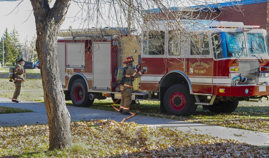 Firefighters from the 5th Civil Engineer Squadron unload gear during a training exercise at Minot Air Force Base, N.D., Nov. 9, 2016. The squadron is required to conduct one no-notice exercise per year to ensure readiness. (U.S. Air Force photo/Airman 1st Class Christian Sullivan)