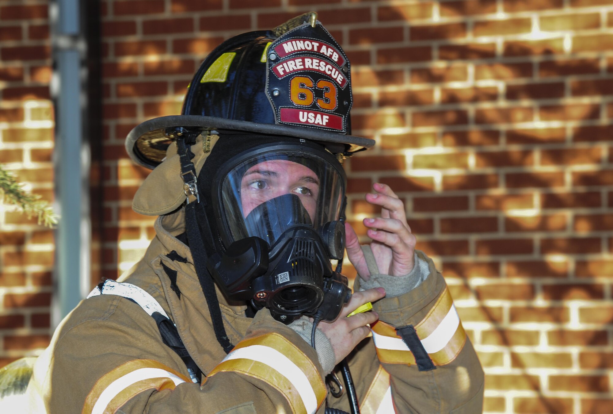 Airman 1st Class Benjamin Cox, 5th Civil Engineer Squadron firefighter, dons his gear during a training exercise at Minot Air Force Base, N.D., Nov. 9, 2016. The fire protection flight trains on a daily basis to ensure readiness for any fire related emergencies. (U.S. Air Force photo/Airman 1st Class Christian Sullivan)