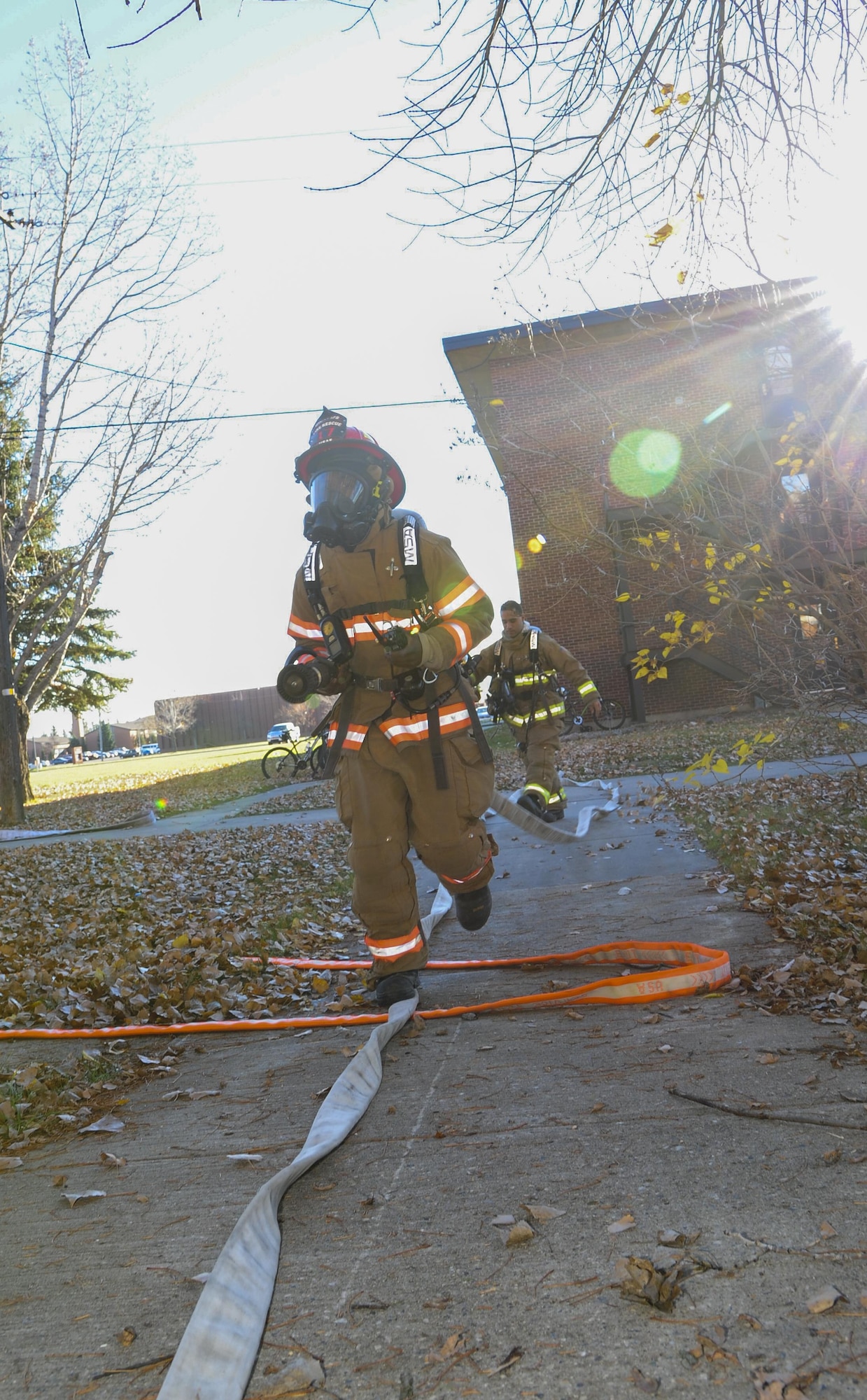 Senior Airman Brandon Vernon, 5th Civil Engineer Squadron firefighter, carries a hose into a building during a training exercise at Minot Air Force Base, N.D., Nov. 9, 2016. The fire
protection flight routinely trains to ensure preparedness for any emergencies on base. (U.S. Air Force photo/Airman 1st Class Christian Sullivan)