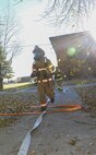Senior Airman Brandon Vernon, 5th Civil Engineer Squadron firefighter, carries a hose into a building during a training exercise at Minot Air Force Base, N.D., Nov. 9, 2016. The fire
protection flight routinely trains to ensure preparedness for any emergencies on base. (U.S. Air Force photo/Airman 1st Class Christian Sullivan)