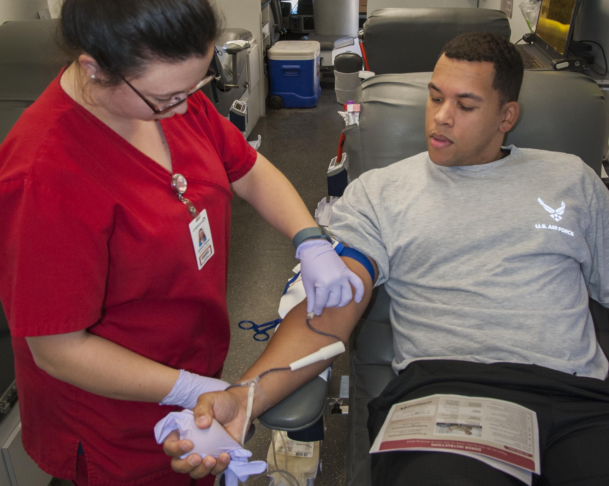 Michael Scroggins, 96th Security Forces Squadron, donates blood as LeAnna Pitman, One Blood Drive donor services specialist, monitors the progress during a blood drive at Bldg. 1 Nov. 15 at Eglin Air Force Base, Fla.  All donors received wellness checkups, which included iron count; blood pressure; temperature check and cholesterol screenings.  (U.S. Air Force photo/Kevin Gaddie)