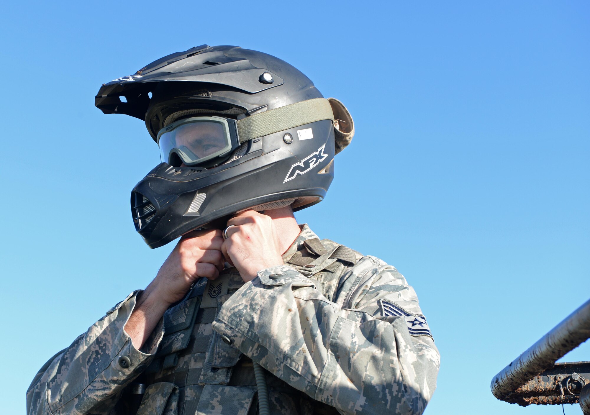 Tech. Sgt. Jeremy Delvaux, 9th Security Forces Squadron flight chief, dons a helmet for a coyote patrol Nov. 4, 2016, at Beale Air Force Base, California. Security forces’ personnel wear safety equipment and receive training to ensure their safety on patrols. (U.S. Air Force photo/Airman Tristan D. Viglianco)