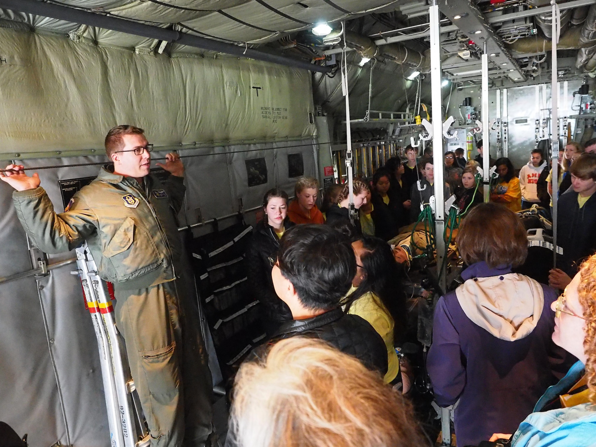 Staff St. James Goetze, 96th Airlift Squadron loadmaster, explains some of the capabilities of the C-130 to members of the Ames High School Orchestra.        
