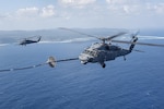 An MC-130H Combat Talon II from the 1st Special Operations Squadron refuels an HH-60 Pave Hawk from the 943rd Rescue Group during Exercise Keen Sword 17 Nov. 7, 2016, near Okinawa, Japan. U.S. forces will conduct training with their Japan Self-Defense Force counterparts at military installations throughout mainland Japan, Okinawa and in the waters surrounding Japan.